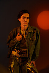 Fashion-forward non binary individual embraces identity in vivid sunset ambiance