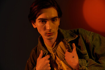 Fashionable non binary individual expresses vibrant identity in dynamic setting
