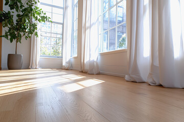 Obraz premium Modern loft room with geometric curtains and a lively plant in the corner bathed in vibrant natural light