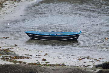 Naklejka premium Blue wooden fishing boat moored at sea