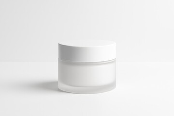 A minimalistic white cosmetic cream jar with a frosted glass base and a matte white lid, standing centered on a clean white background
