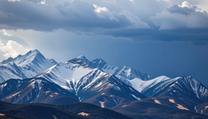 Fototapeta premium a brooding storm descended upon the majestic rocky mountains, its dark, ominous clouds raining a cascade of water upon their snow dusted peaks in the rugged heart of central colorado.