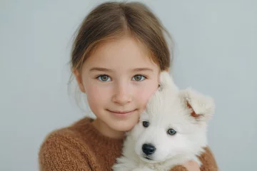 smiling child hugs fluffy pet minimalistic composition with ample copy space natural blurred background