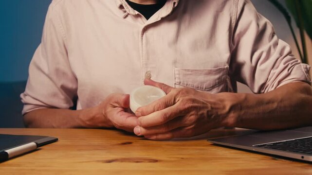 Snus nicotine tobacco close up, pack of tobacco for gum. unhealthy addiction. Man opening box with snus and taking one. 