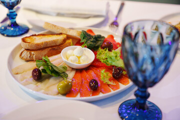 fish cut, butter and toast on a plate. 