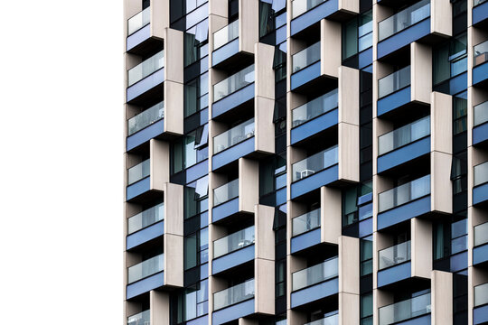 Detailed close-up of modular white and blue building facade, with strong shadows and dynamic grid pattern, great for modernism, abstraction and architectural texture.