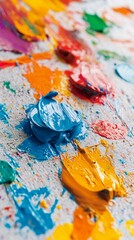 Fototapeta premium Vibrant oil paint blobs in blue, yellow, and red create a textured artistic landscape, showcasing the rich, dynamic texture of creative expression on canvas.