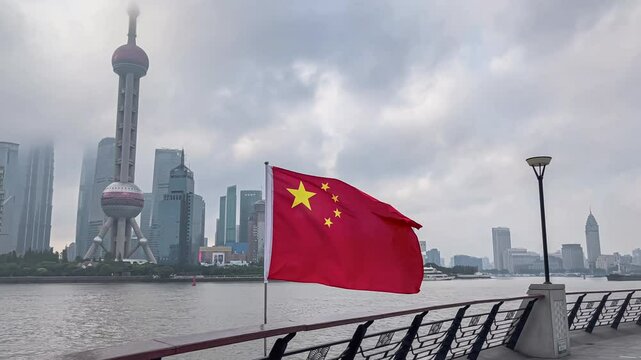 Coastal walkway along the Huangpu river on the North Bund of Shanghai. Chinese flag is waving