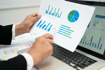 Asian business woman working with financial graph.