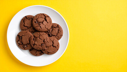 Fototapeta premium Round chocolate cookies on white plate. Delicious snack. Tasty dessert. Sweet food. Close-up.