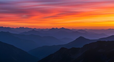 Vibrant  orange Sunset Over Layered Mountain Ridges