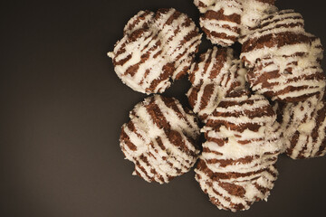 Profiteroles with coconut cream on a black background.