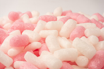 Pink and white box filler as a background. Top view.