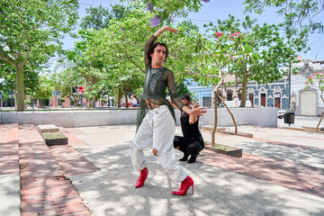 Vogue dance two performers perfoming in city streets. Pride and lgbt concept.