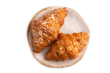Croissant on blue plate isolated on white, top view, close up