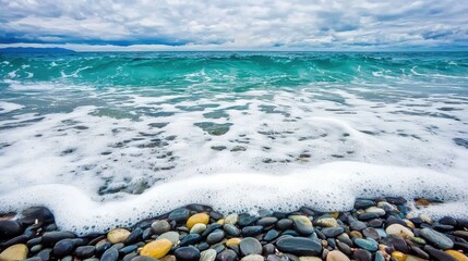Tranquil Seascape with Gentle Waves Crashing on Colorful Pebble Beach Under Cloudy Sky