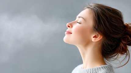 Woman inhaling steam, peaceful expression