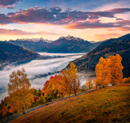 Exciting autumn view of foggy Zell lake. Wonderful sunrise on Zell am See town, Austria, Europe....