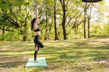 Asian beautiful woman doing yoga and meditation in the park.