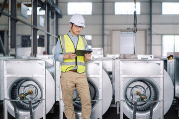 asian male engineer working on digital tablet in factory of fan