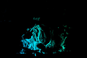 Vibrant Blue and Green Flames in the Dark Background at Night