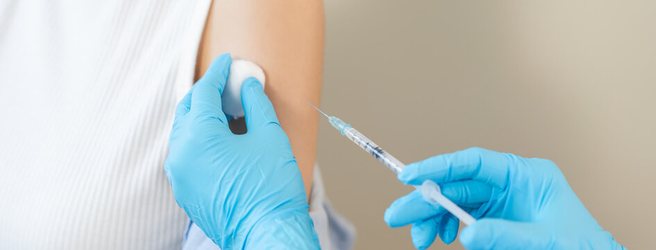 Health care, corona virus, hand of woman nurse, doctor giving syringe vaccine, injection dose on arm sick patient at clinic. Vaccination, immunization disease prevention against flu pandemic influenza