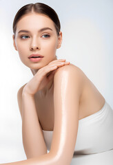 An ethereal close-up of a young woman, white background, skin care concept