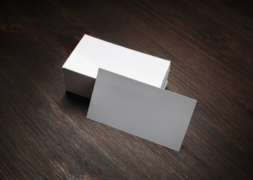 Blank business cards on wooden background. Mockup for branding identity.