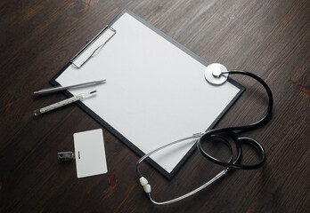 Medical still life. Blank clipboard, stethoscope, thermometer, pen and badge.