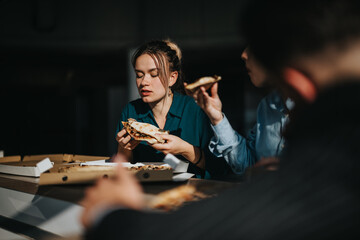 Business colleagues taking a relaxed pizza break in a modern office. The image captures a moment of...