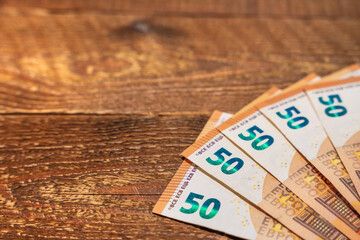 Folded 50 euro bills on a wooden table