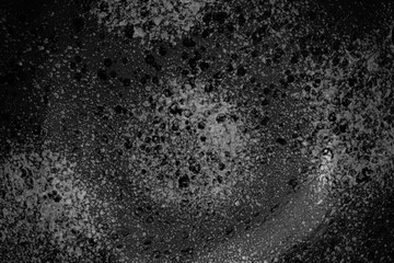 Detailed texture of black and white bubbles forming abstract patterns in liquid surface