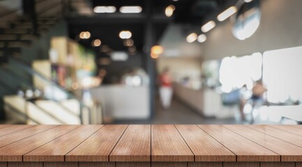 Empty wooden table top with lights bokeh on blur restaurant background.