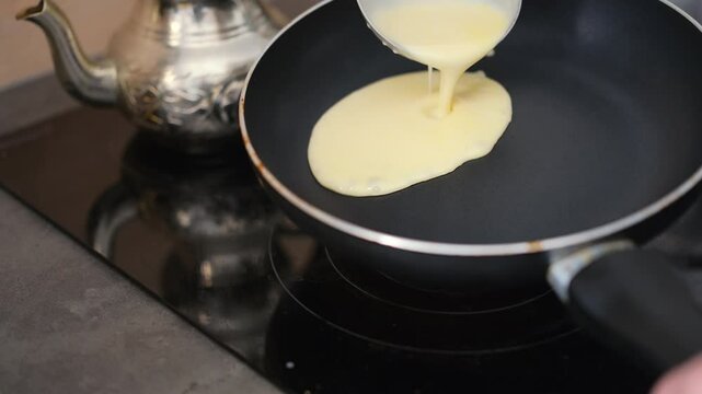 Chef pouring batter on hot pan, rising steam, footage of homemade pancakes being made in a cozy kitchen, warm and homey breakfast of delicious homemade pastries, close-up of pancakes