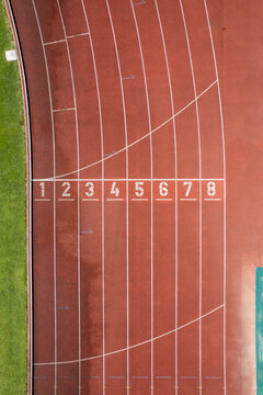 Aerial view of the Manuela Machado Municipal Stadium in Viana do Castelo, Portugal. Eight empty red tracks for running sports with tartan track of synthetic rubber on the athletic stadium.