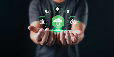A person holds out their hands beneath glowing eco icons and a green CO2 cloud symbol, representing...