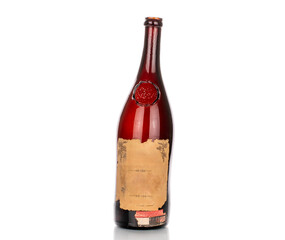 One empty bottle of old collectible wine, close-up, isolated on white background.