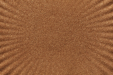 Cosmetic make up beauty product. Dry simmering pressed bronzer deep brown colored textured background.