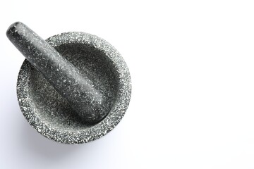 Stone mortar and pestle on white background, top view. Space for text