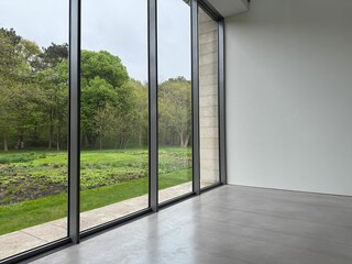Empty room with panoramic windows and grey floor