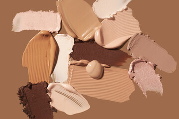 Beauty product sample swatches. Texture of smudge cosmetic make up cream foundation and bronzer, concealer, highlighter liquid background