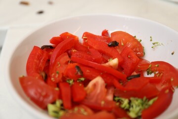 Cockroaches and vegetables in bowl on table, closeup