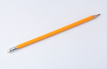 Sharp graphite pencil on light background, top view