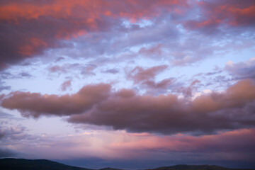 Colourful clouds in the evening sky over the mountains