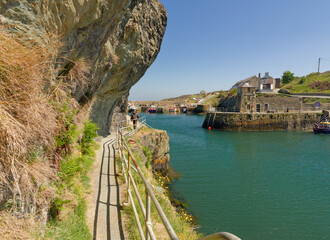 Amlwch Anglesey. A walkway is next to a body of water at the small fishing port