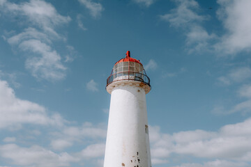 A lighthouse is standing tall in the sky