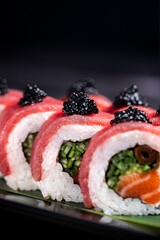 Tuna  Caviar Sushi Roll – A luxurious sushi roll with fresh tuna slices, black caviar, salmon, and vibrant greens, elegantly plated for a gourmet experience.