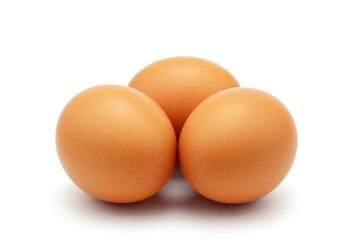 Three brown eggs isolated on white background, arranged in a pyramid