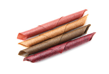 Delicious fruit leather rolls on white background, top view
