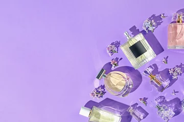 Zelfklevend Fotobehang Flat lay composition with perfume bottles and lilac flowers on violet background. Space for text © New Africa